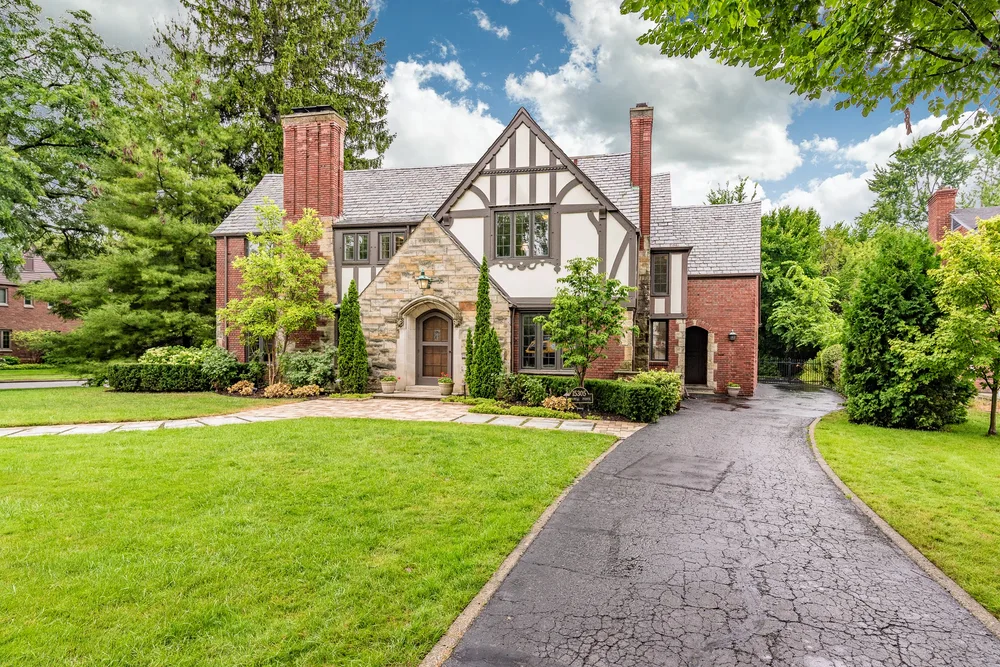 Tudor-style brick and stone home exterior — residential real estate photography